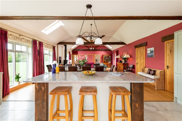 huge granite island in the kitchen and living area in background